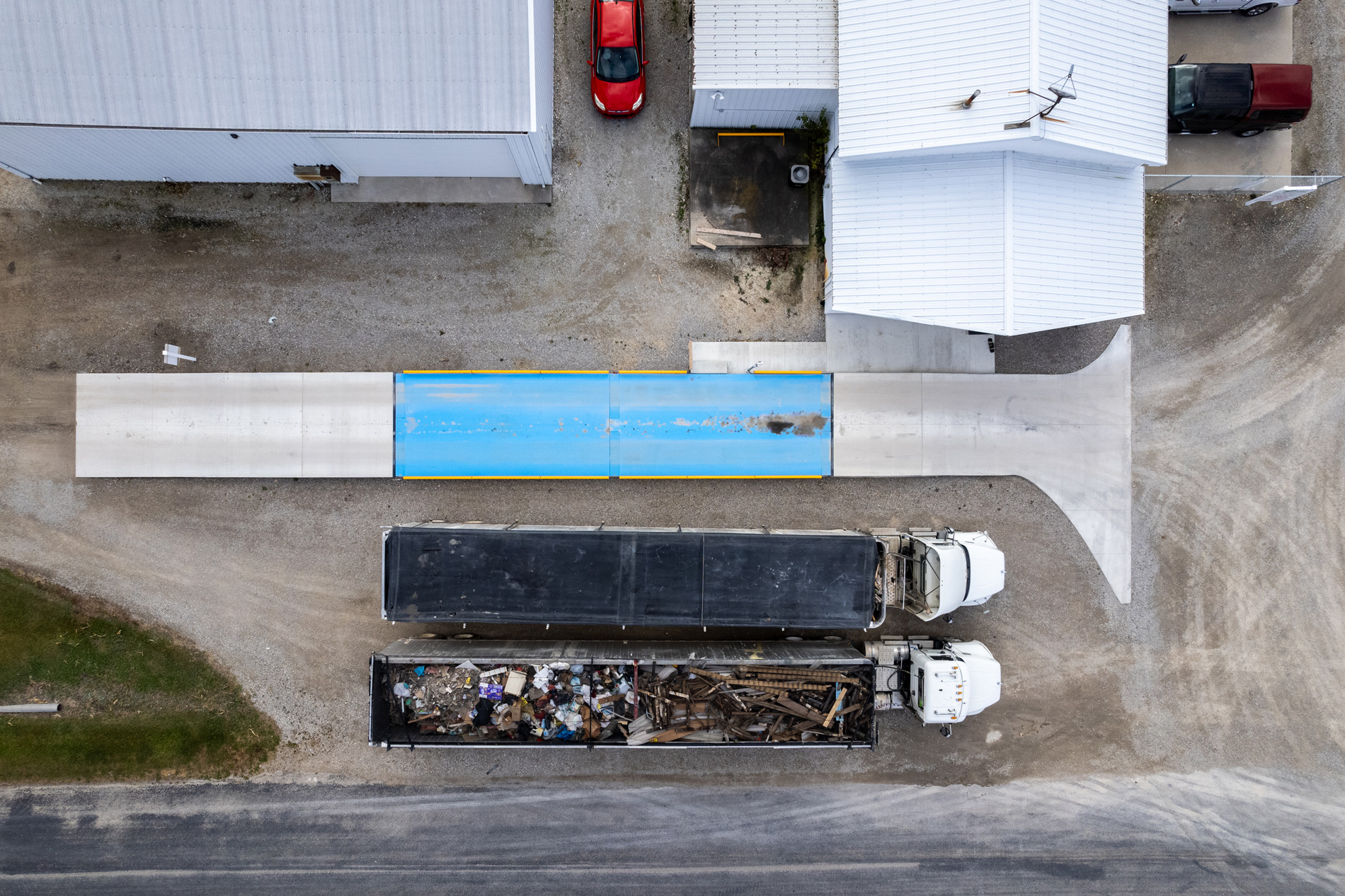 Overhead view of a truck crossing the Tonner Transfer Station scale, loaded with waste material